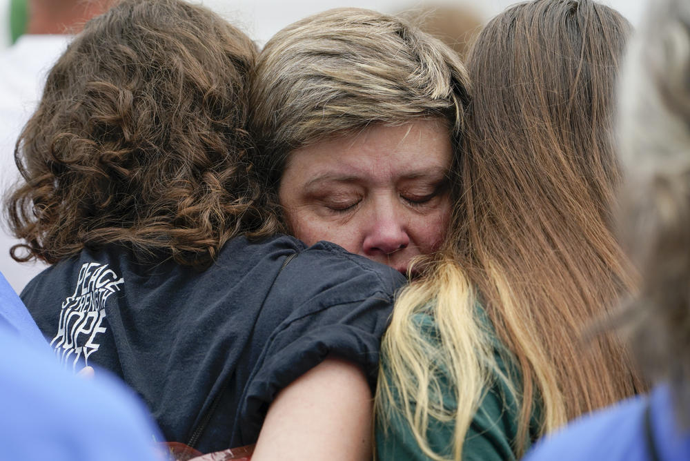 Karin LaBanca comforts two survivors of the mass shooting at Sandy Hook Elementary school after a man tried and failed to rush the stage during the second March for Our Lives rally.