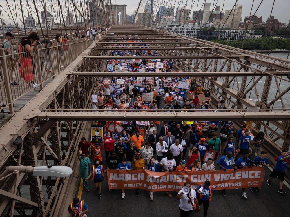 Demonstrators march across the Brooklyn Bridge during the 