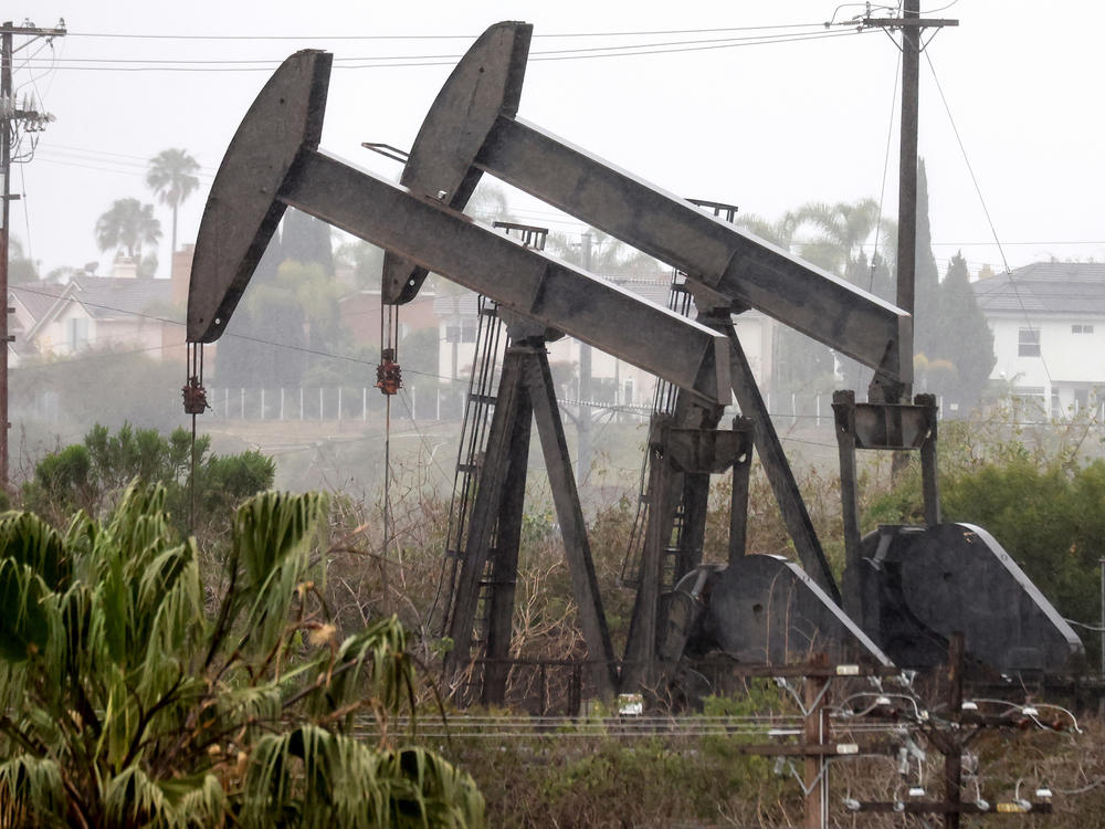 An oil pumpjack operates as another stands idle on March 28 in Los Angeles. U.S. oil producers face constraints in ramping up oil production.