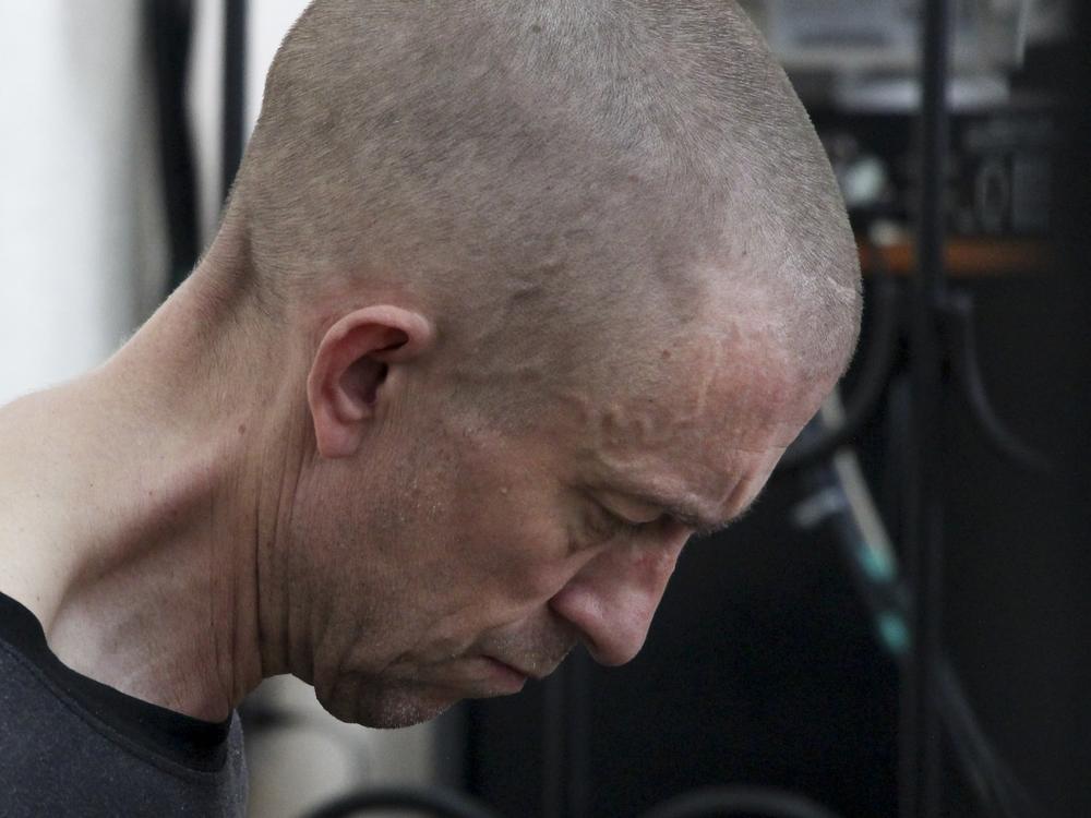 British citizen Shaun Pinner sits behind bars in a courtroom in Donetsk, in the territory which is under the Government of the Donetsk People's Republic control, eastern Ukraine, Thursday, June 9, 2022.