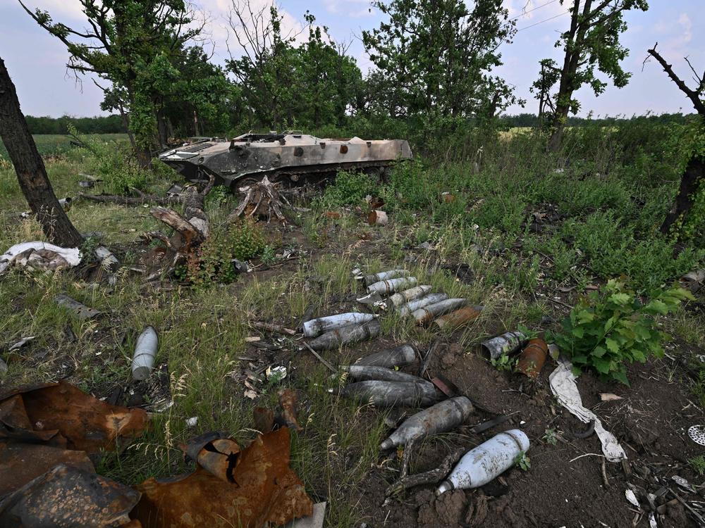 Artillery shells sit on the ground ground next to destroyed Russian military vehicles on a field not far of southern city Mykolaiv on Sunday.
