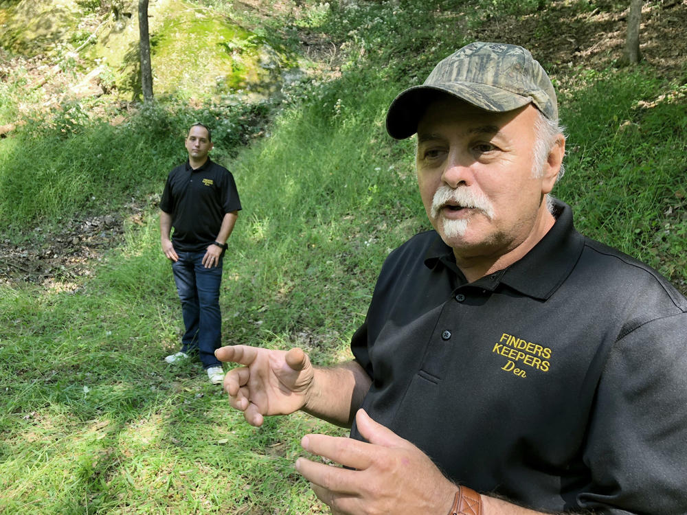 Dennis Parada, right, and his son Kem Parada stand at the site of the FBI's dig for Civil War-era gold in September 2018 in Dents Run, Penn. A scientific report commissioned by the FBI shortly before agents went digging for buried treasure suggested that a huge quantity of gold was below the surface.