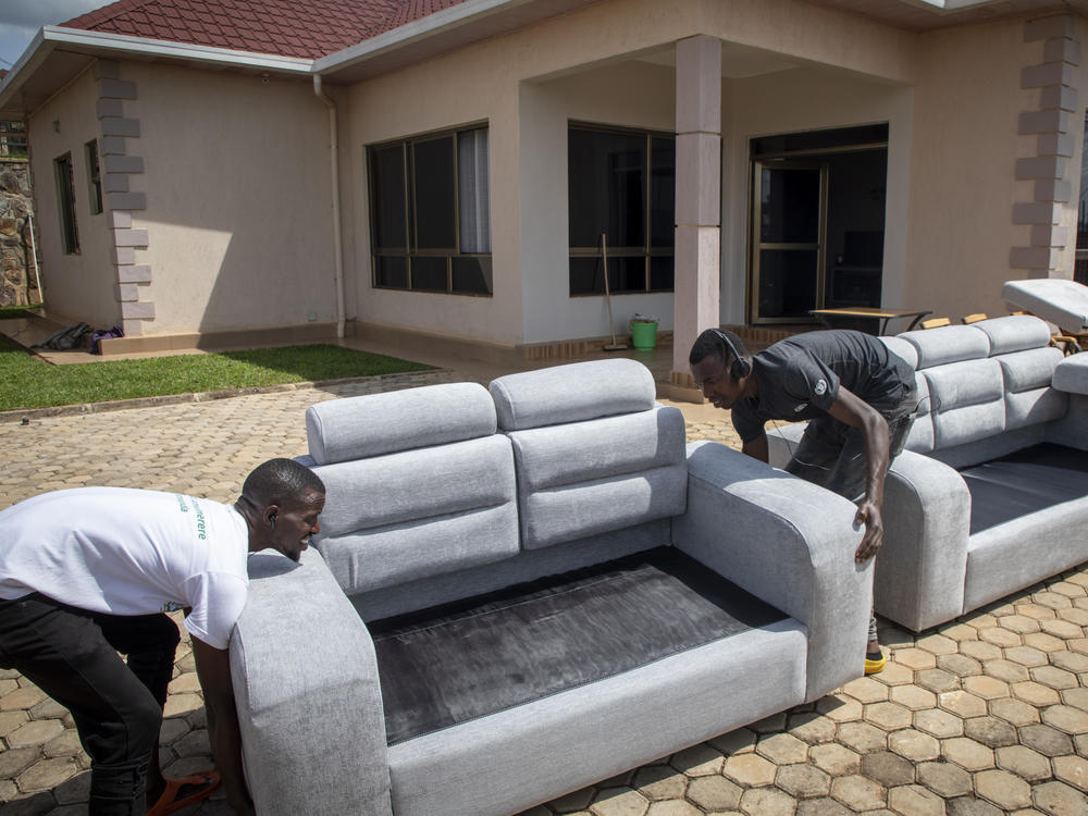 People carry furniture into one of the locations expected to house some of the asylum-seekers due to be sent from Britain to Rwanda, in the capital Kigali, Rwanda on May 19, 2022.
