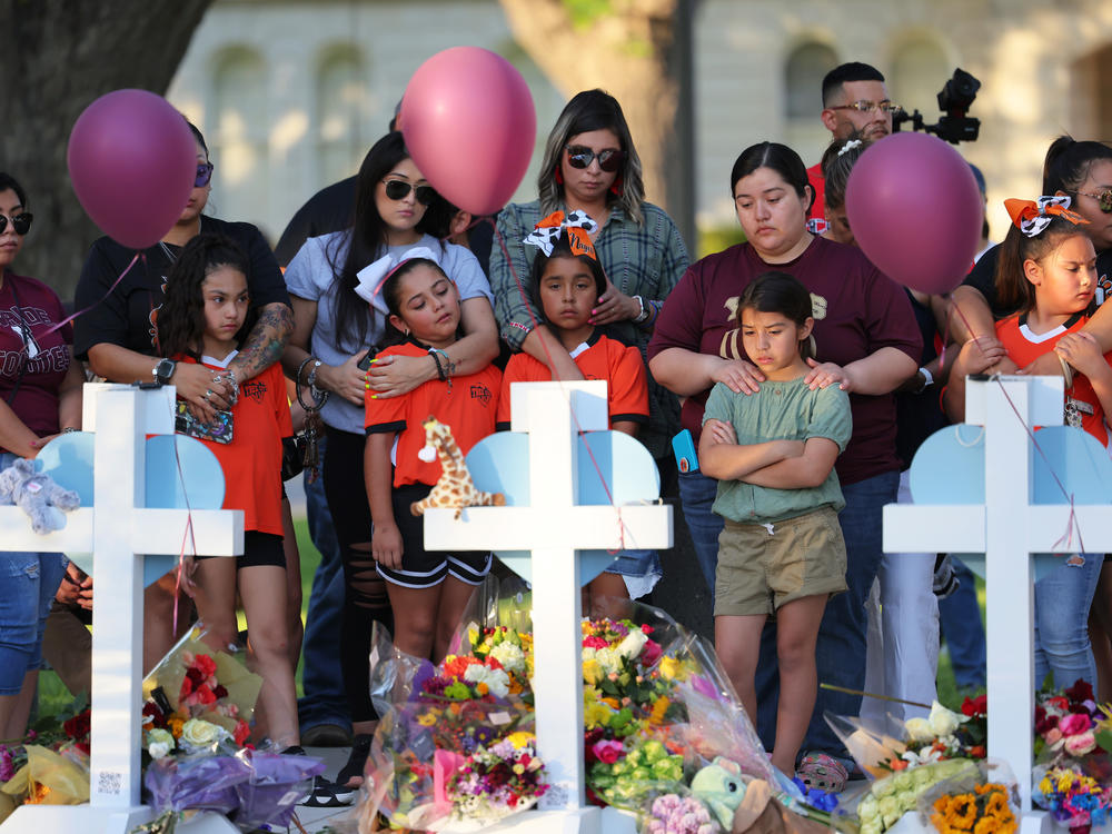 People visit memorials for victims of the shooting in Uvalde, Texas.