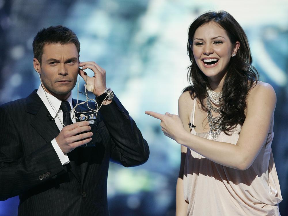 <em>American Idol</em> finalist Katharine McPhee and host Ryan Seacrest during the Season 5 final performances in 2006.