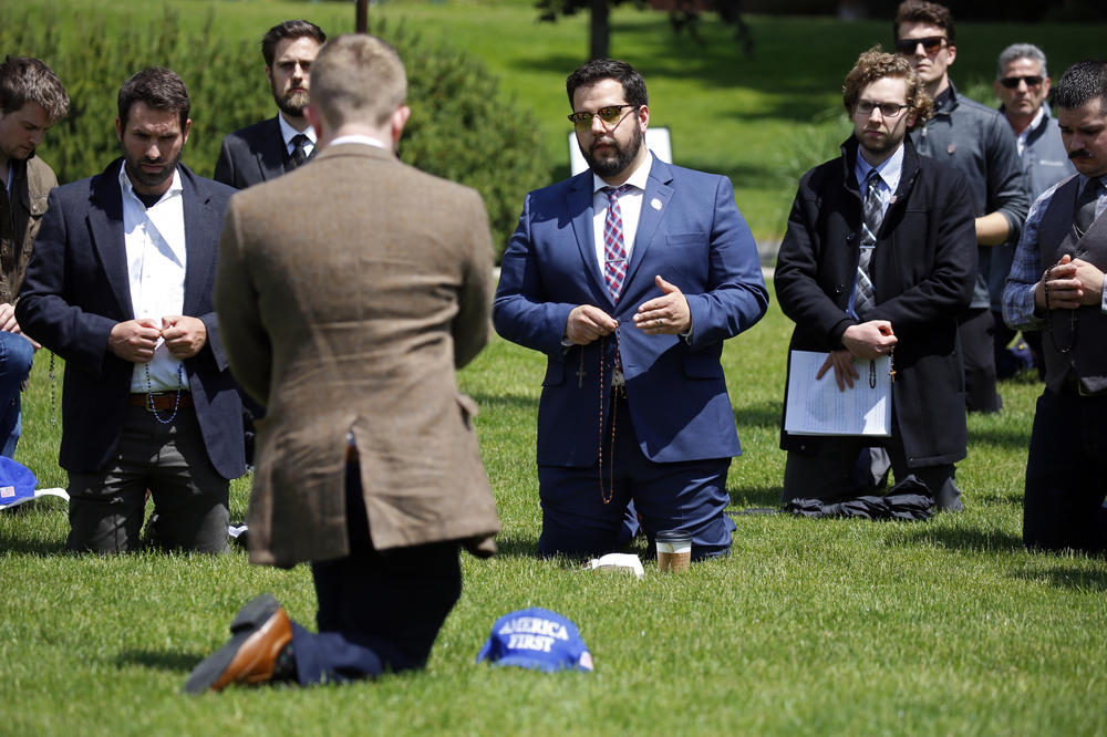 Christian-nationalist Dave Reilly holds a rosary as he leads a conservative group in prayer at the Coeur d'Alene Public Library in protest of the LGBTQ+ community's 