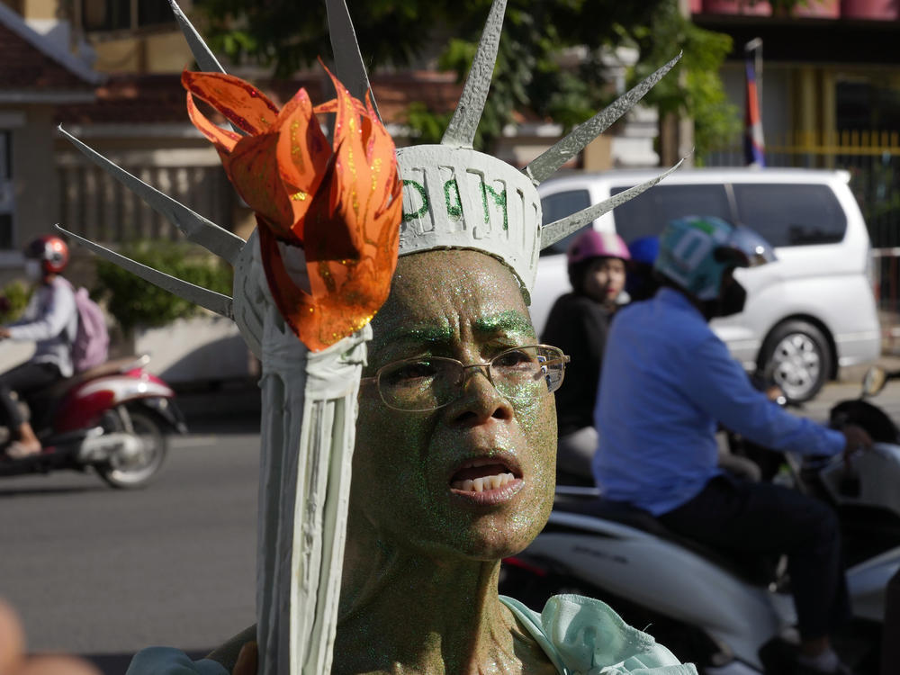 Cambodian-American lawyer Theary Seng, dressed in the Lady Liberty talks to the media outside Phnom Penh Municipal Court in Phnom Penh, Cambodia, Tuesday, June 14, 2022.