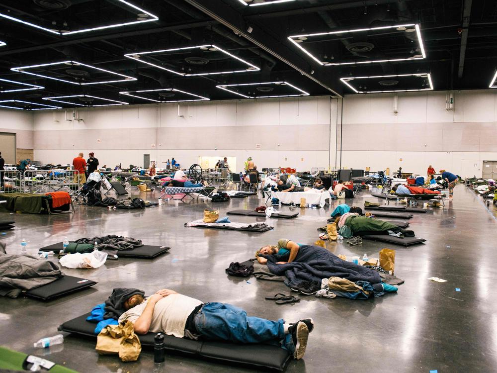 People rest at the Oregon Convention Center in Portland, Ore., in June 2021 during a record-breaking heat wave that killed hundreds of people in the Pacific Northwest. Temperatures soared above 110 degrees.