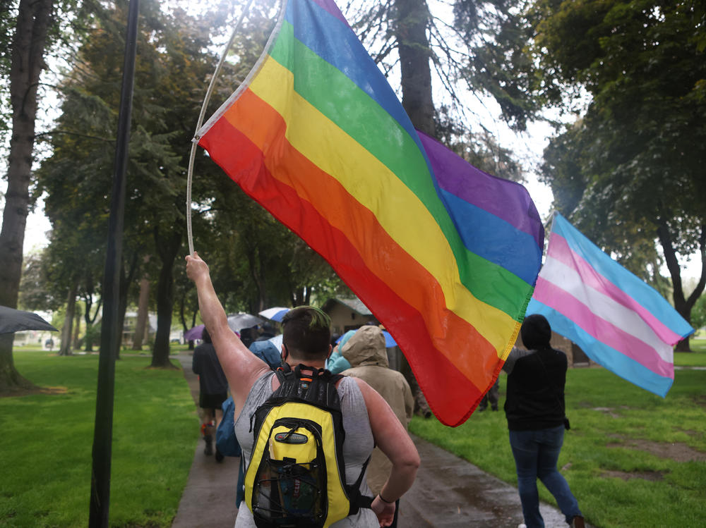 Members and supporters of the LGBTQ community march during the Pride in the Park event in Coeur d'Alene, Idaho, on Saturday. Law enforcement said members of a far-right group were arrested for planning to riot near the march.