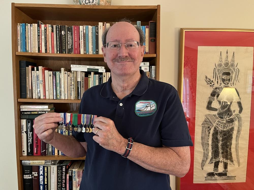 Lew Toulmin is a genealogist who has been working with the Clotilda Descendants Association. He's a member of a number of genealogy societies, and keeps membership medals in his Maryland home