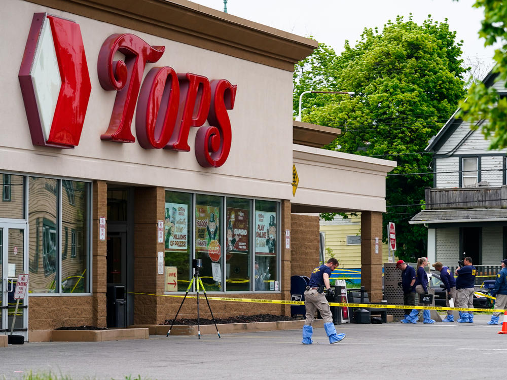 Investigators work the scene last month after the mass shooting at a supermarket in Buffalo, N.Y.