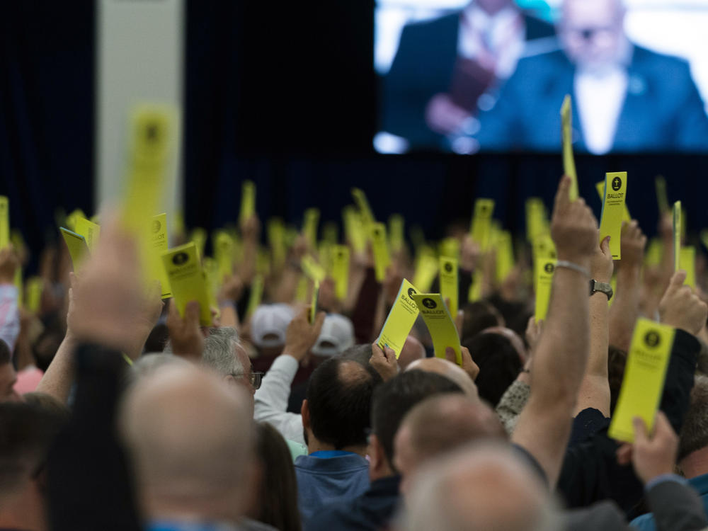 Attendees hold up their ballots during a session at the Southern Baptist Convention's annual meeting in Anaheim, Calif., Tuesday, June 14, 2022.