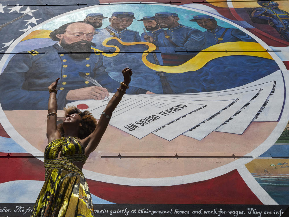 Dancer Prescylia Mae, of Houston, performs during a dedication ceremony for the mural <em>Absolute Equality</em> in downtown Galveston, Texas on June 19, 2021.