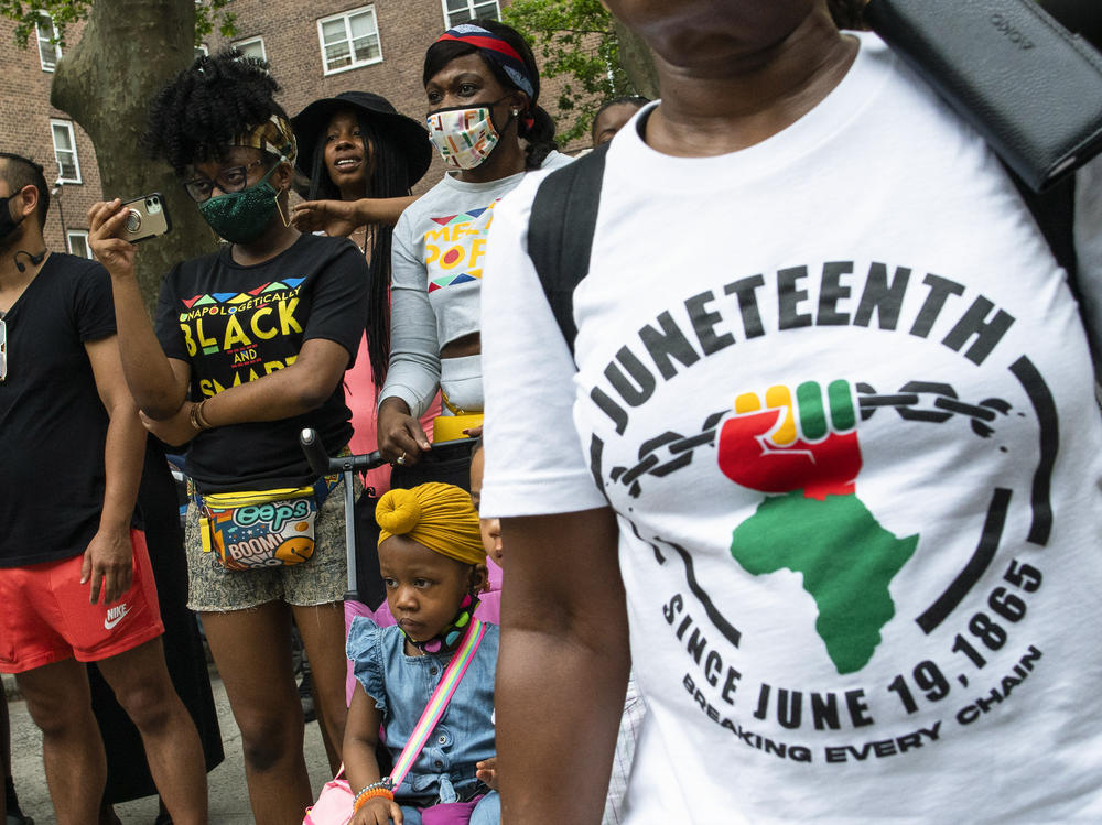 People attend Juneteenth celebrations in the Harlem neighborhood of New York, on June 19, 2021.