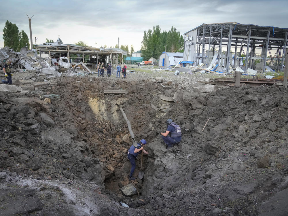 Police inspect a crater caused by a Russian rocket attack in Pokrovsk, in eastern Ukraine's Donetsk region, on Wednesday.