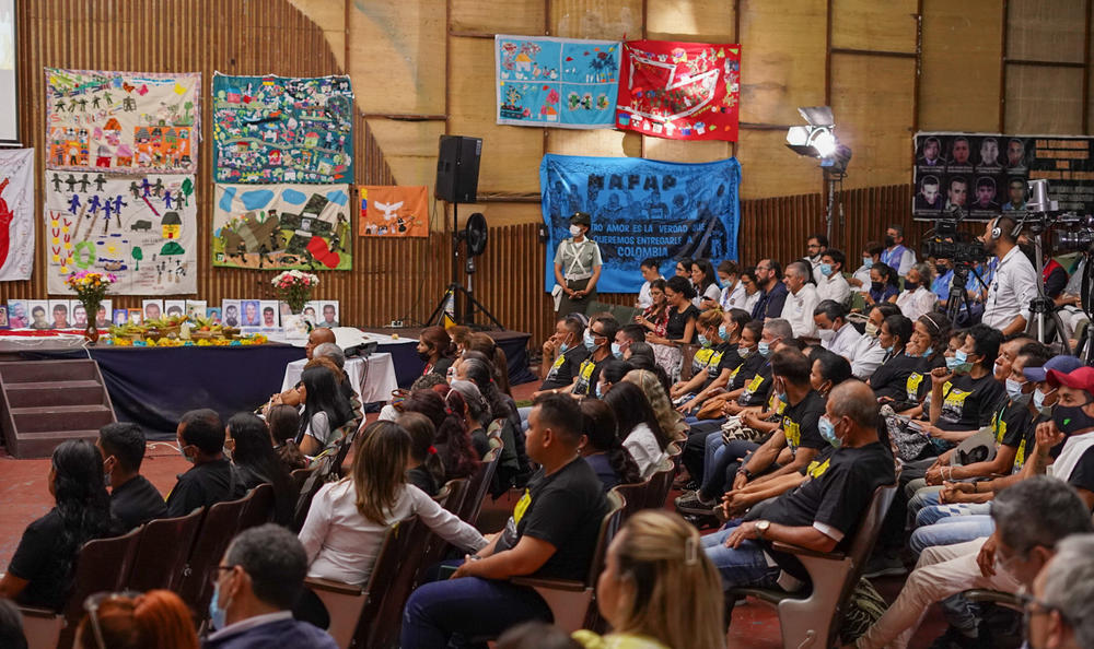 Victims and loved ones fill the audience of the tribunal and photos, flowers, messages and other items line the walls in the auditorium of Francisco de Paula Santander University in Ocaña, Colombia, on April 26.