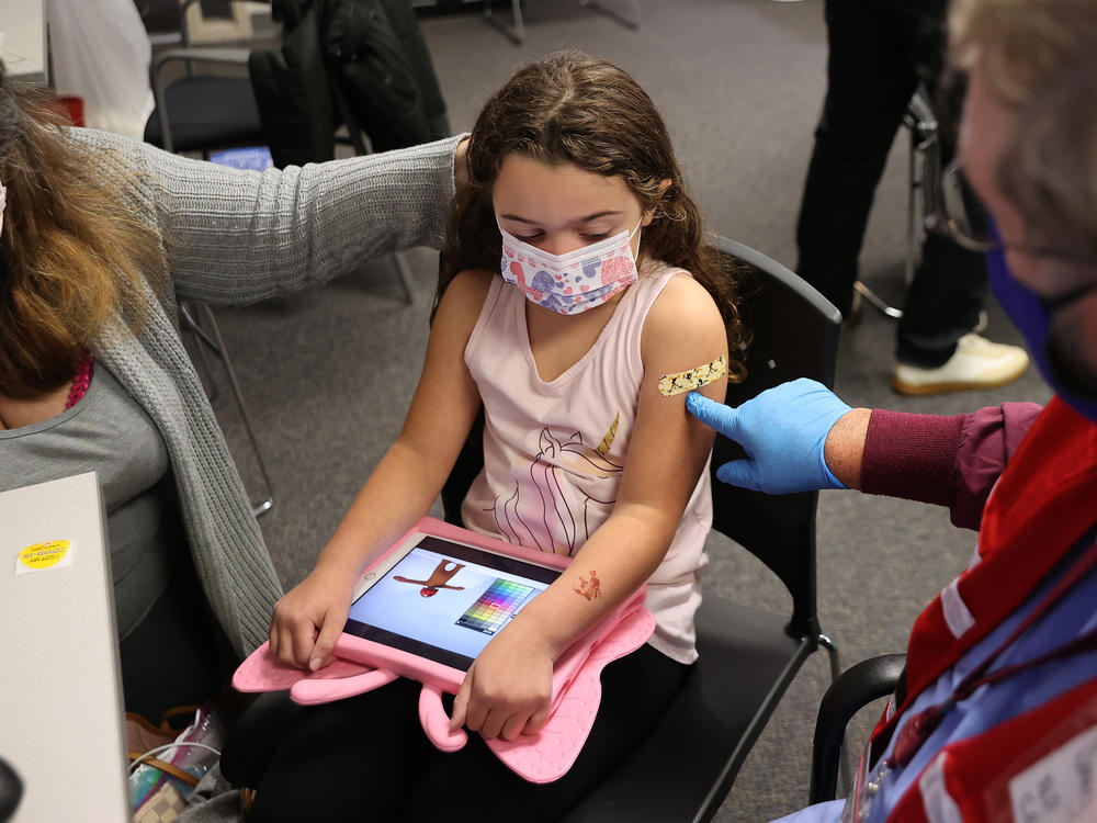 A child receives the Pfizer BioNTech COVID-19 vaccine at the Fairfax County Government Center in Annandale, Va.,  in November 2021. A committee of advisers to the Food and Drug Administration recommended Wednesday that the agency expand authorization of COVID-19 vaccines to children as young as 6-months-old.