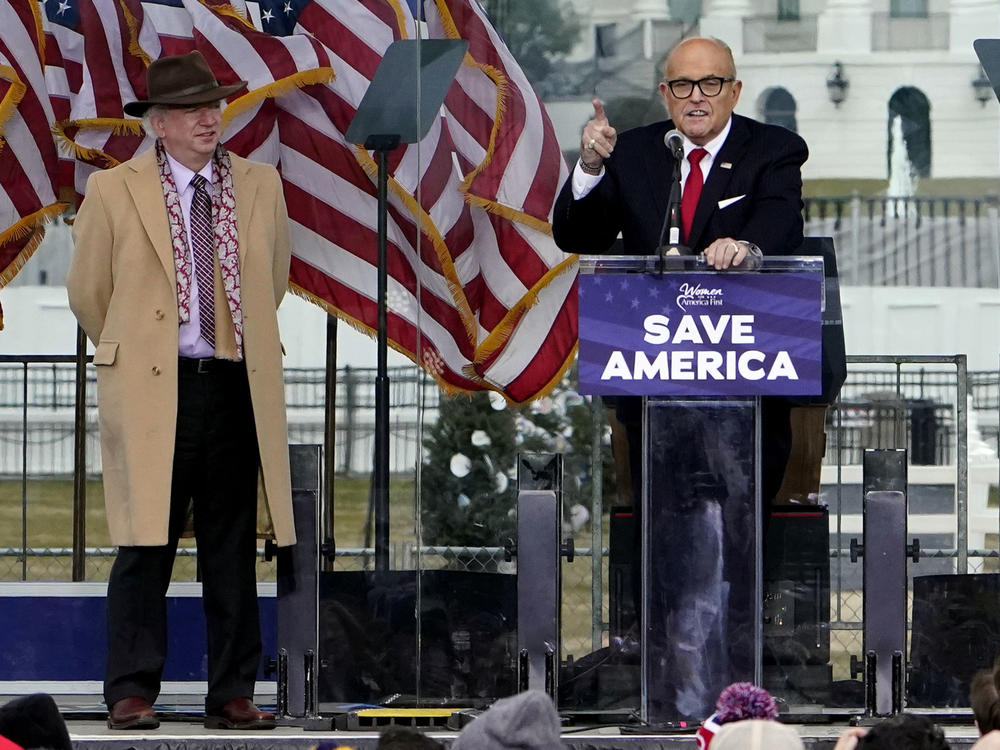 John Eastman, left, listens as former New York Mayor Rudy Giuliani speaks at the Jan. 6, 2021, 