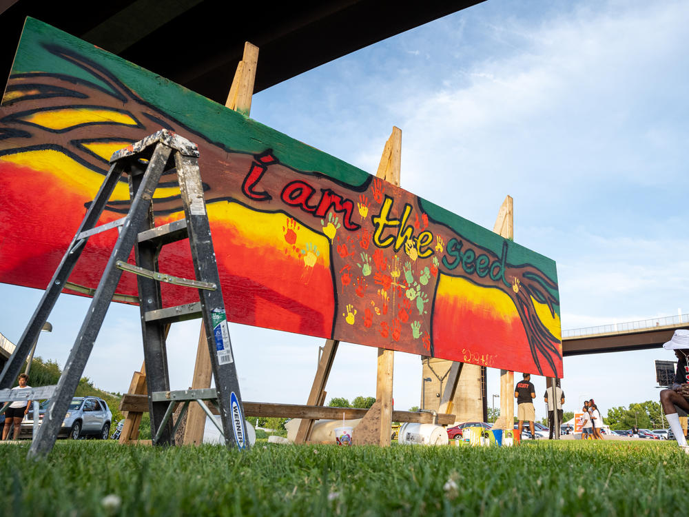 Juneteenth, or Emancipation Day, commemorates the end of slavery on June 19, 1865, in Galveston, Texas, in compliance with President Lincoln's 1863 Emancipation Proclamation. Here, a young woman stands near a piece of art created during the Louisville Juneteenth Festival at the Big Four Lawn on June 19, 2021, in Louisville, Ky.