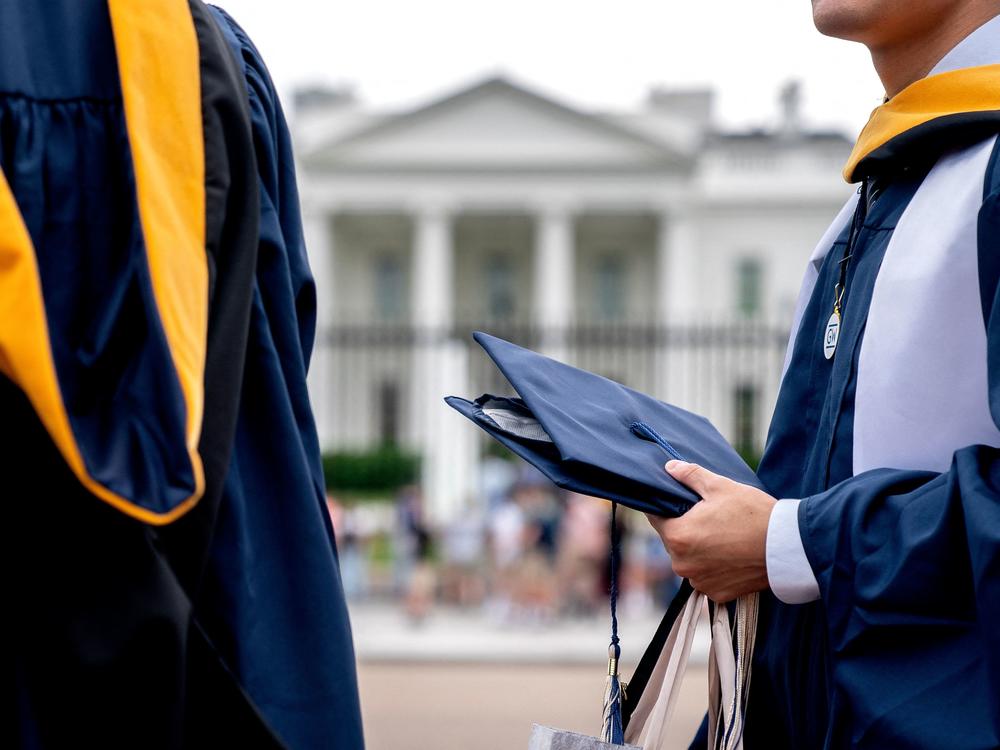 Students from George Washington University wear their graduation gowns outside the White House in May.