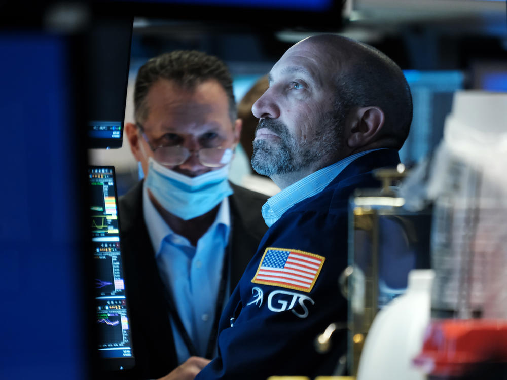 Traders work on the floor of the New York Stock Exchange (NYSE) in New York City on Thursday. Stocks fell sharply a day after the Fed raised interest rates by the most in decades.