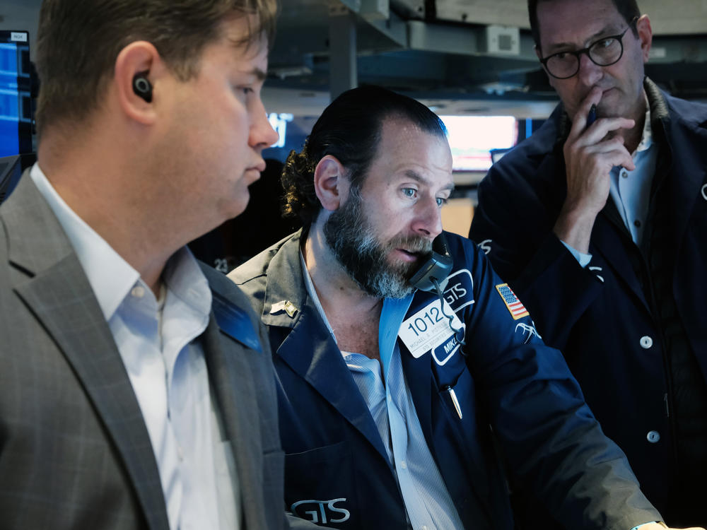 Traders work on the floor of the New York Stock Exchange (NYSE) in New York City on Thursday. Fears about the Fed's aggressive actions against inflation have raised concerns about the impact on the economy.