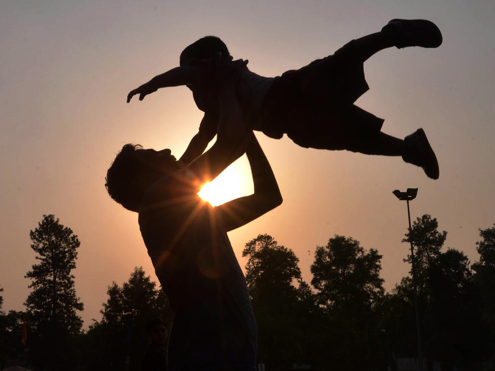 A father plays with his son at a park in Amritsar, India, on Father's Day in June 2016.