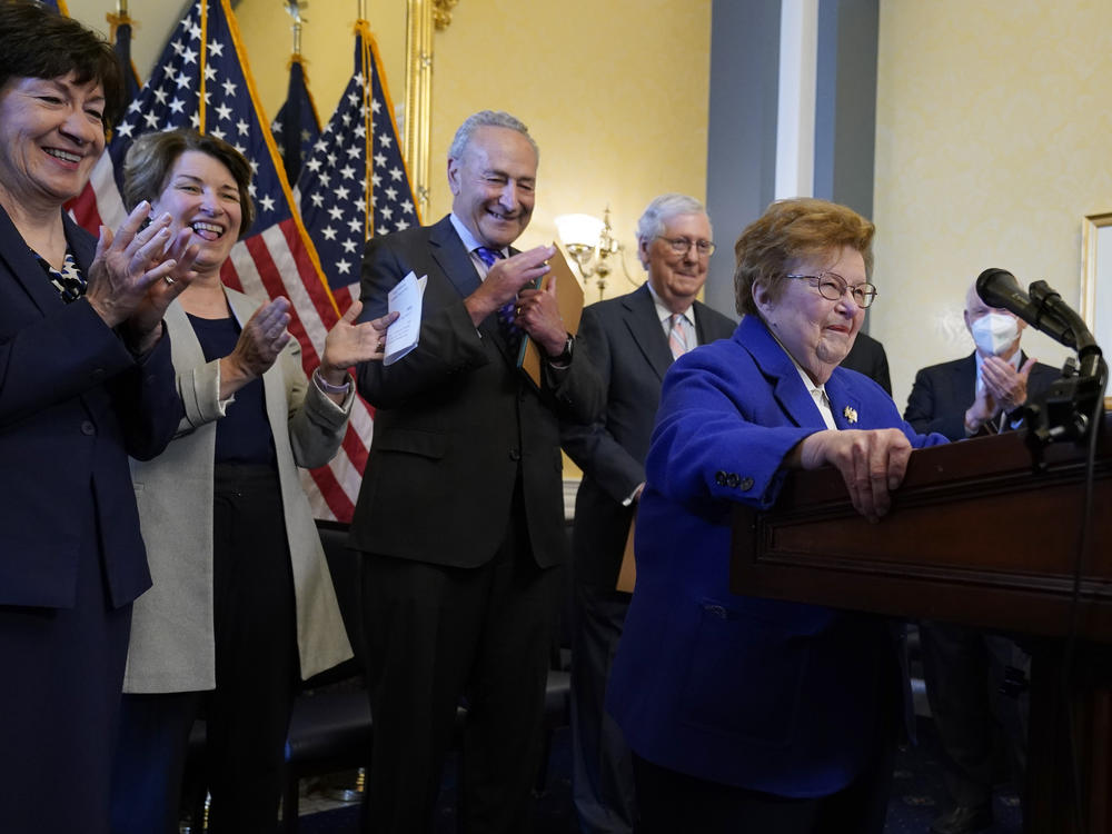 Former Sen. Barbara Mikulski, D-Md., surrounded by senators, jokes about having a podium her size during the room dedication ceremony in Washington, D.C., on Wednesday. She retired in 2017 after 45 years in Congress.