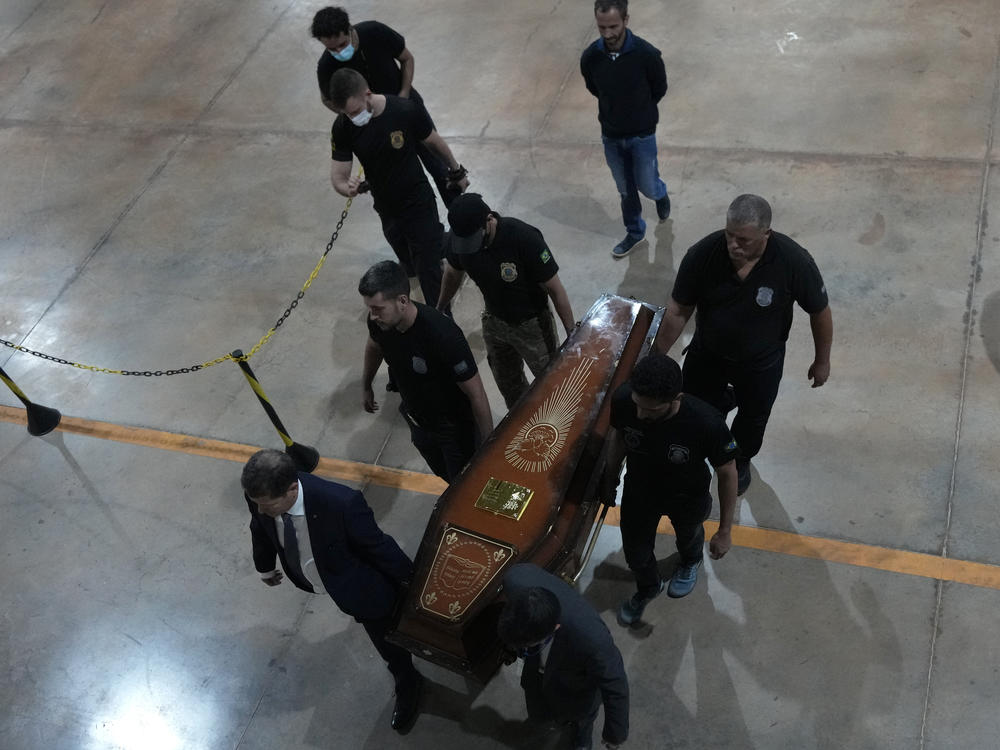 Federal police officers arrive with recovered human remains believed to be of the Indigenous expert Bruno Pereira of Brazil and freelance reporter Dom Phillips of Britain, at the federal police hangar in Brasília, Brazil on Thursday.