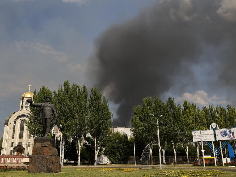 Smoke rises from a burning house following shelling in Donetsk, eastern Ukraine, on Friday.