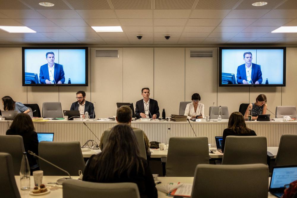 Grenoble Mayor Éric Piolle arrives in the municipal council as people protest in front of the Grenoble Metropolis headquarters on May 16 as the Municipal Council votes on allowing the wearing of the burkini in the city's swimming pools.