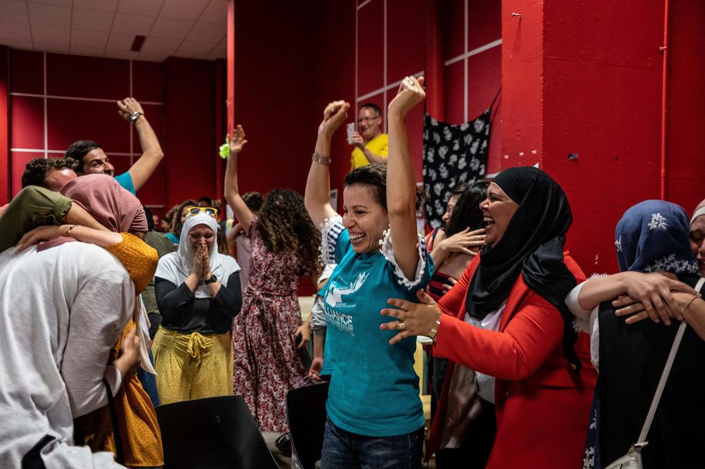 Members of the pro-burkini association Alliance Citoyenne celebrate after members of the municipal council voted to allow the wearing of the burkini in the city's swimming pools, in Grenoble on May 16.