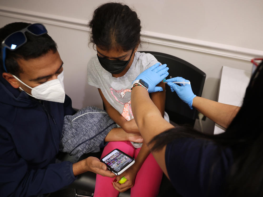 A child receives the Pfizer BioNTech vaccine at the Fairfax County Government Center in Annandale, Va., last November. Vaccines will soon be available for children as young as 6 months old.