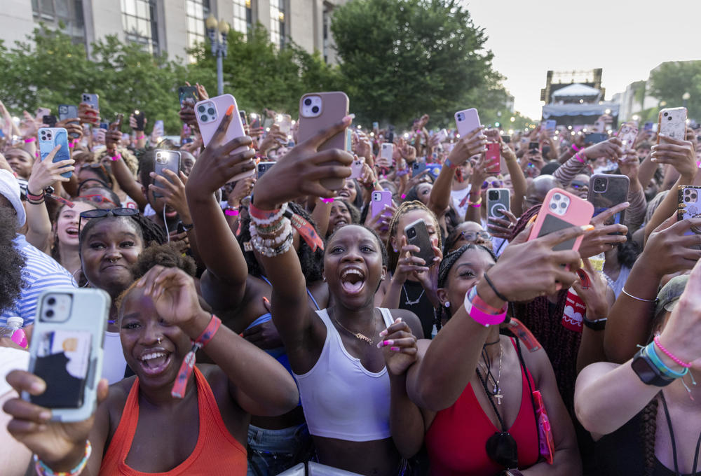 Crowds scream and raise their phones as performer Moneybagg Yo comes onto the stage on Friday, June 17.