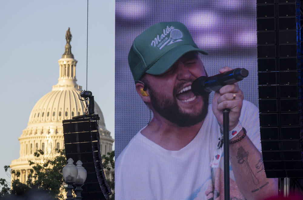 Quinn XCII is shown on a large monitor with the U.S. Capitol in the background on Fri., June 17.