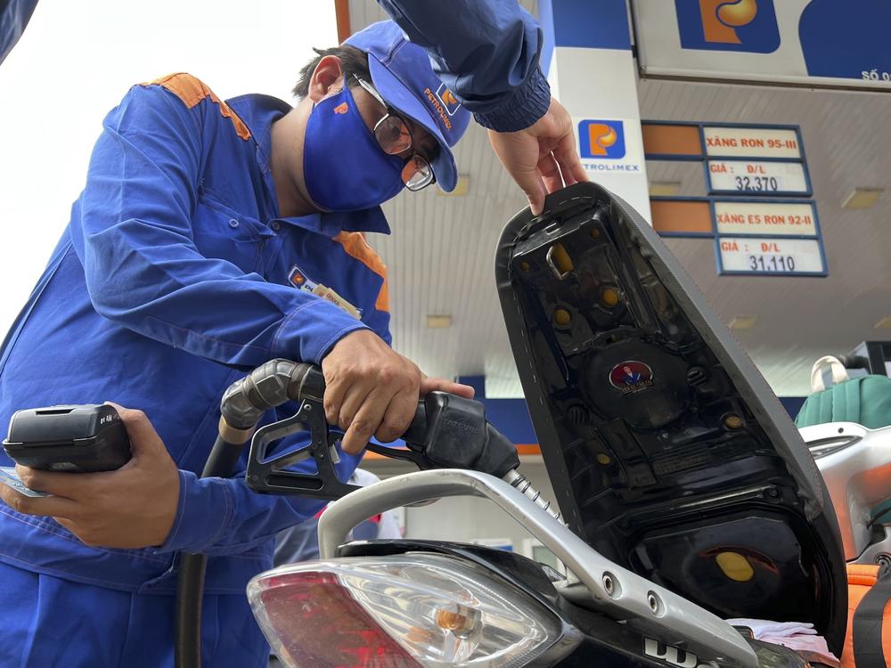 An attendant pumps gas into a motorcycle in Hanoi, Vietnam Sunday, June 19, 2022. Across the globe, drivers are rethinking their habits and personal finances amid skyrocketing prices for gasoline and diesel.