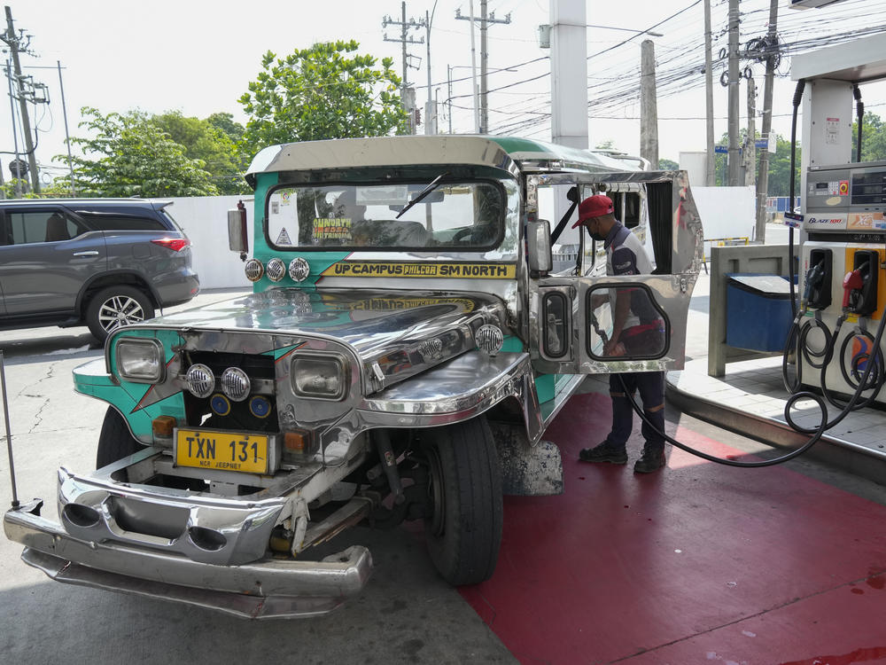 A passenger jeepney driver refuels his vehicle at a gasoline station in Quezon City, Philippines on Monday, June 20, 2022.