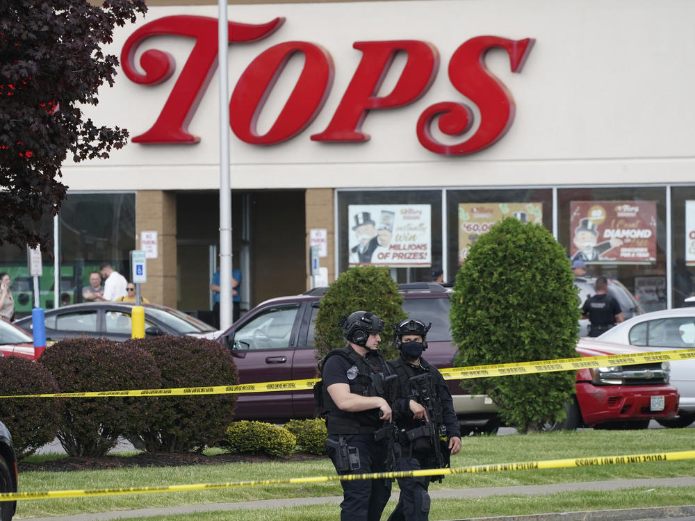 Police secure an area around a supermarket where several people were killed in a shooting, Saturday, May 14, 2022, in Buffalo, N.Y.