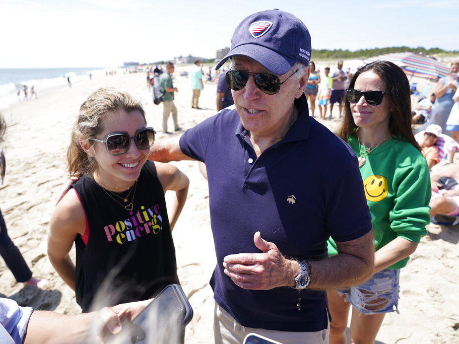 President Joe Biden talks to the media after walking on the beach Monday with his granddaughter Natalie Biden, left, and his daughter Ashley Biden at Rehoboth Beach, Del.