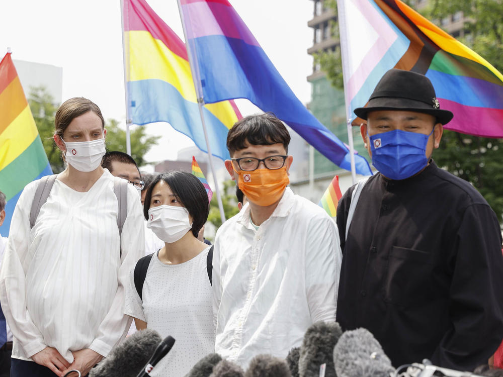 Plaintiffs speak to journalists after a court ruling in Osaka, western Japan Monday, June 20, 2022.