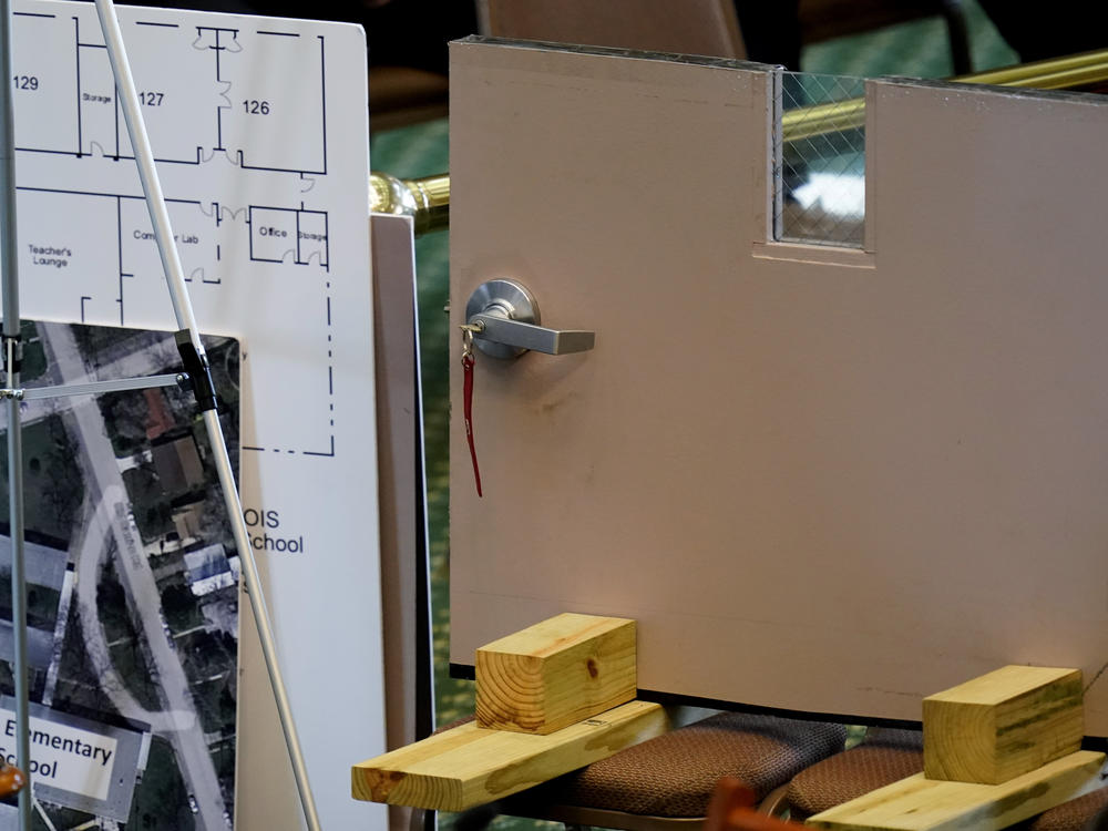 A section of a classroom door from Robb Elementary School in Uvalde, Texas, is shown as Texas Department of Public Safety Director Steve McCraw testifies at a Texas Senate hearing at the state capitol.