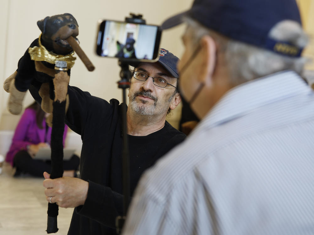 Actor and comedian Robert Smigel performs as Triumph the Insult Comic Dog in the hallways of the Cannon House Office Building on Thursday.