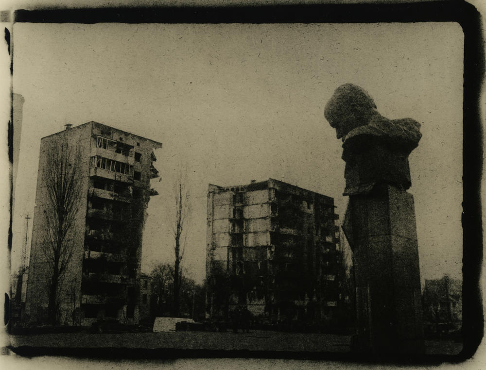 A monument to the poet Taras Shevchenko sits in front of ruined buildings in the city of<em> </em>Borodyanka, Ukraine, in March.