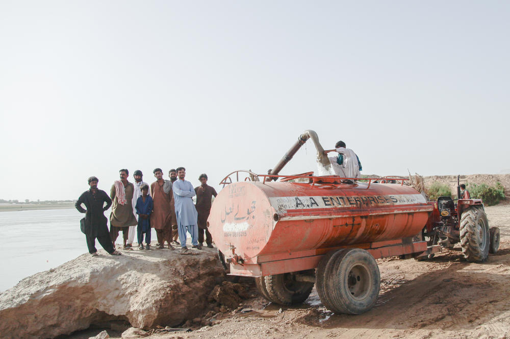 Men fill a tanker with water siphoned from the Indus River near the town of Sehwan in the southern province of Sindh. Due to the lack of piped water in the region, the residents depend on these tankers for water. There was an increased demand for these water tankers during the recent heatwave in April and May.