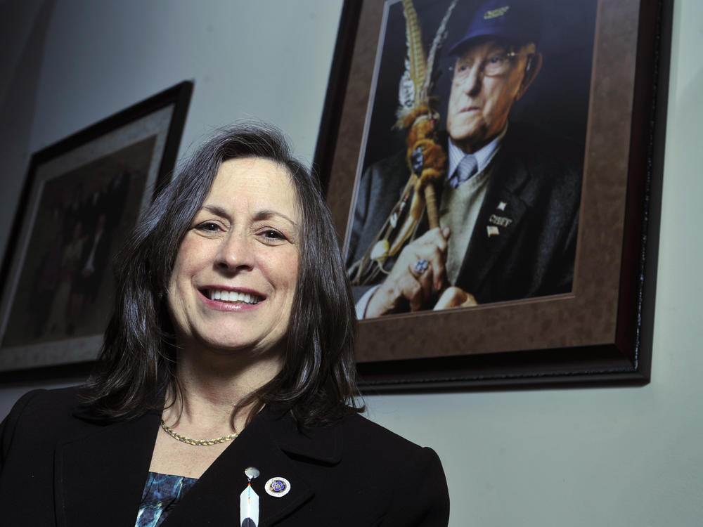 Marilynn Malerba stands next to a photograph of late Chief Ralph Sturges at tribal offices in Uncasville, Conn., on March 4, 2010. On Wednesday, President Biden announced his intent to appoint her U.S. treasurer in a historic first.