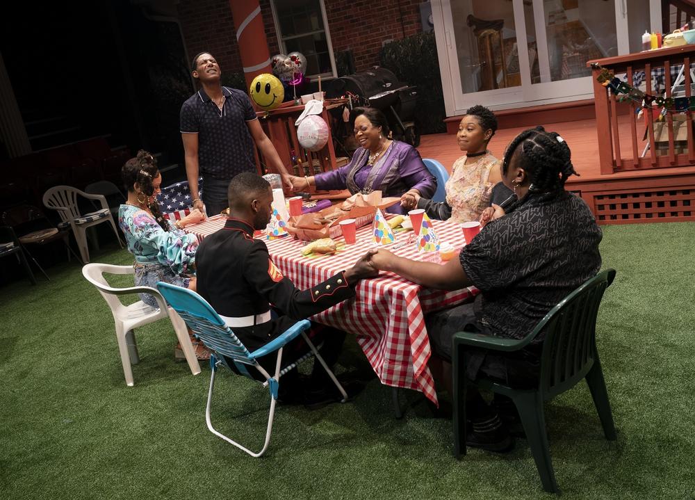 The cast of <em>Fat Ham</em> gathered around the dinner table.