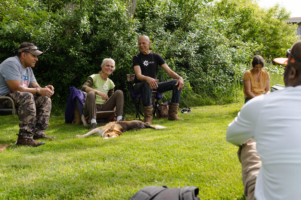 Kevin Devine, Saskia Vanderhoop, David Vanderhoop, and Audrey Van Der Krogt, participate in a group exercise during an employee training at Sassafras Earth Education, an indigenous Wampanoag nonprofit run by the Vanderhoops.