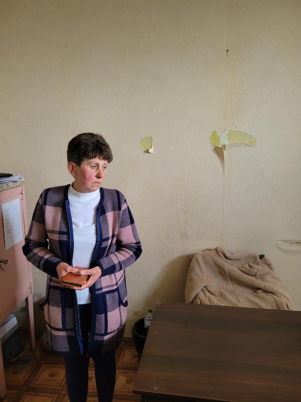 Viktoria Andrusha's mother, Kateryna Andrusha, in her office, damaged by Russian soldiers.