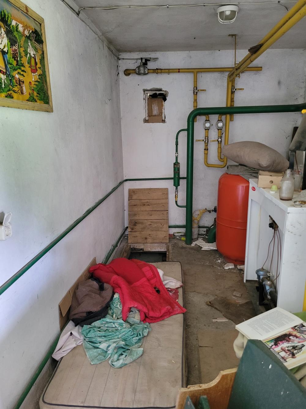 An interior look at left-behind items in the abandoned building where locals believe Viktoria Andrusha was held. In the back is a trap door to the cellar where two men were also held.
