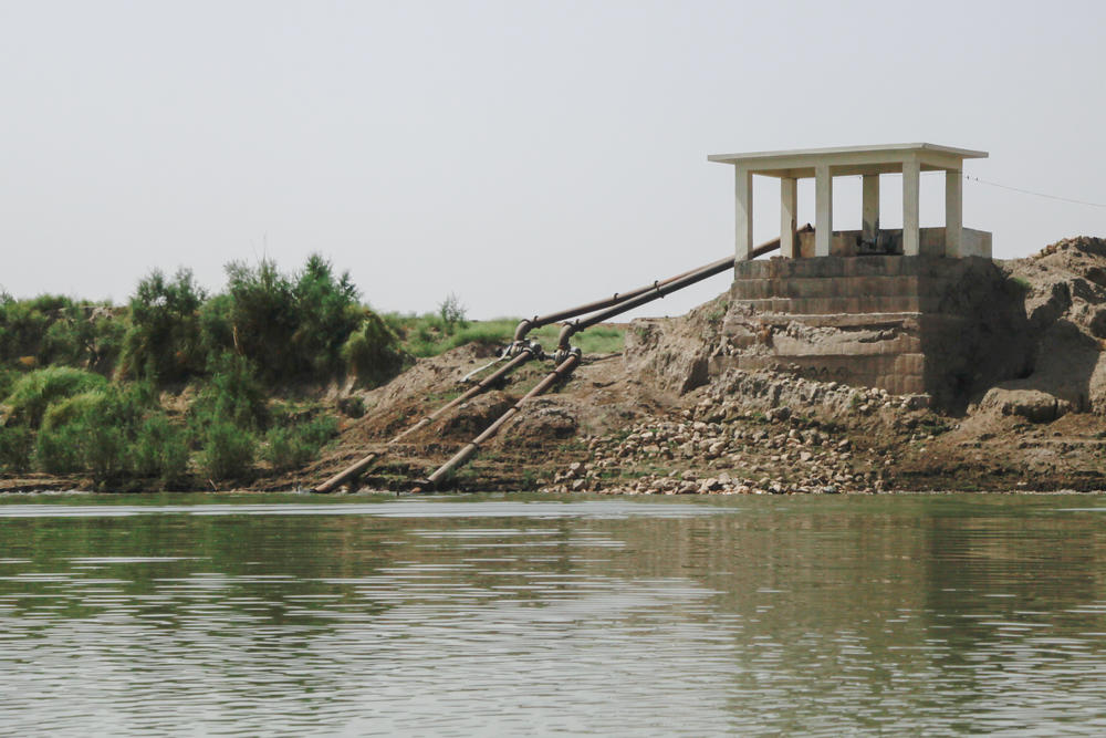 Extraction pipes stretch from the bank of the Indus River into the water. Many pipes are illegally siphoning the river water that is meant for use downstream.